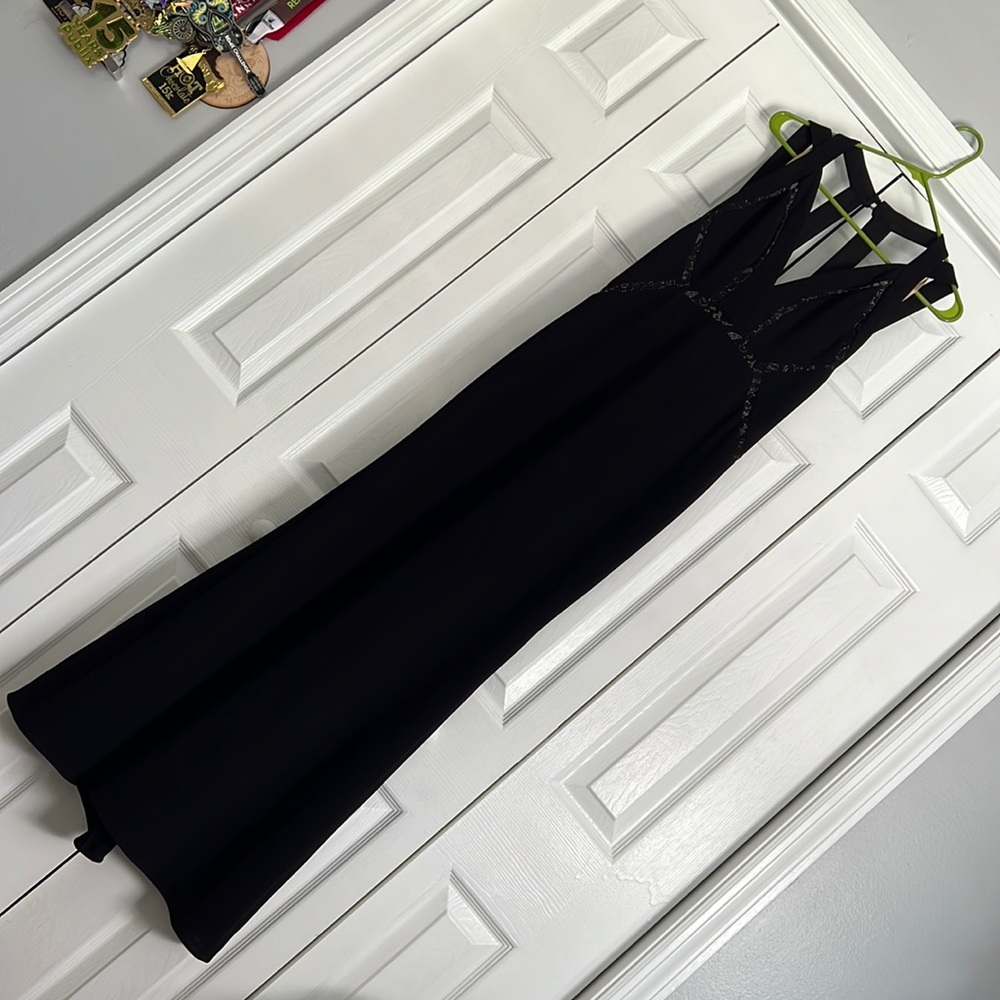 Floor length sexy black dress with straps and sheer lace details.